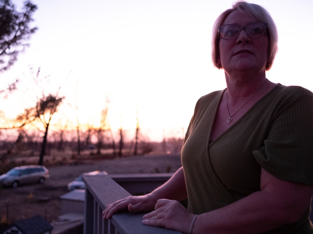 Lori Hornback stands on a balcony in her home.