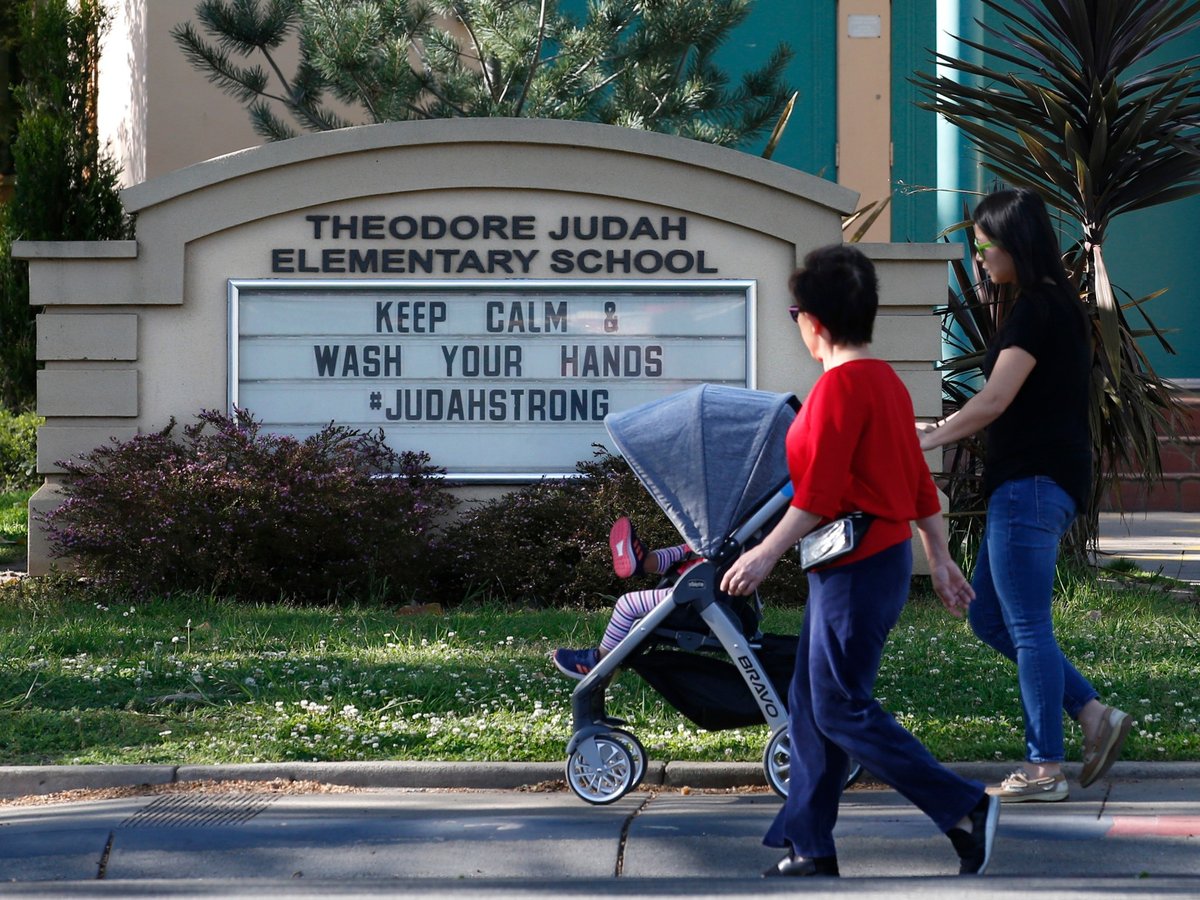A reminder for people to wash their hands is displayed on a sign outside Theodore Judah Elementary School in Sacramento, Wednesday, April 1, 2020.