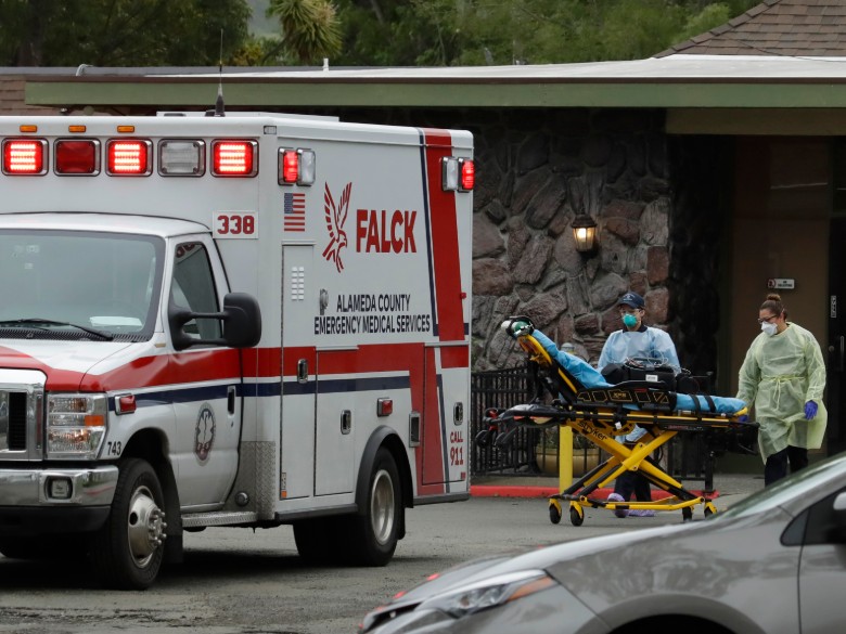 EMT's move a stretcher at the Gateway Care and Rehabilitation Center on Thursday, April 9, 2020, in Hayward, Calif.