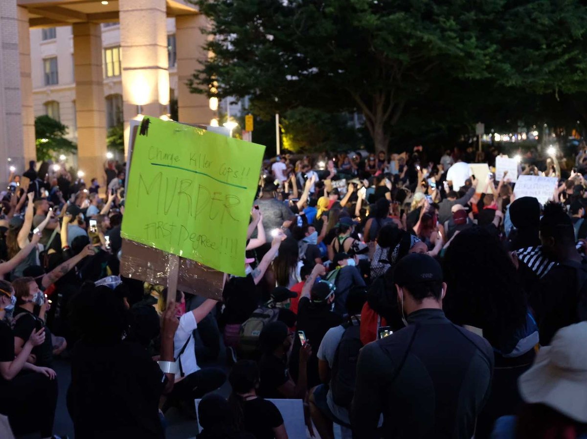 A crowd of demonstrators takes a knee at Sacramento City Hall, protesting against police violence Monday, June 1, 2020.