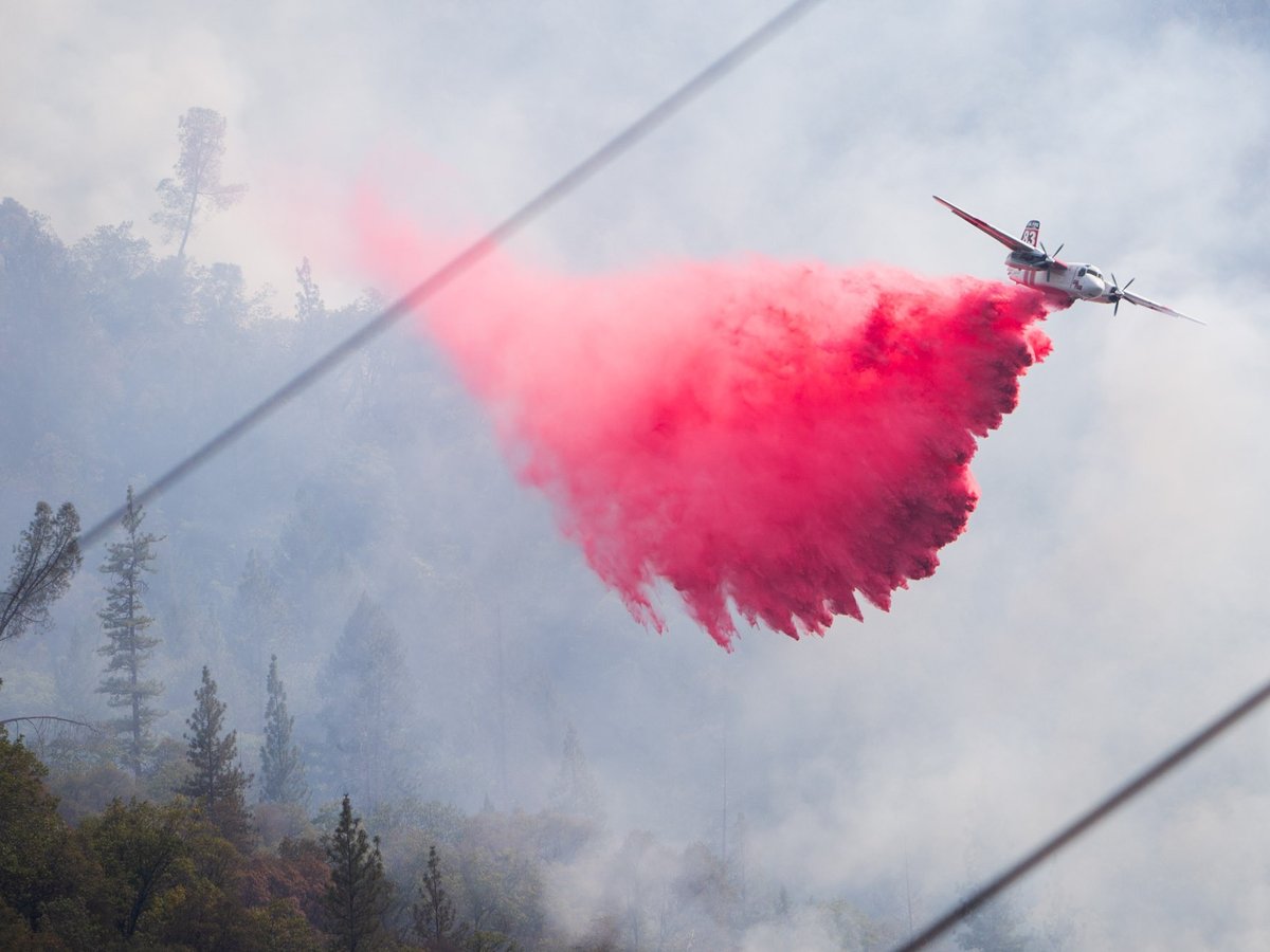 A CalFire plane drops fire retardant on the Jones Fire near Nevada City, Tuesday, August 18, 2020.