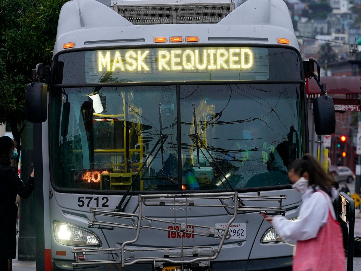 A sign on a San Francisco bus advises that passengers are required to wear masks. Health officials have renewed pleas for Americans to protect themselves and others from the coronavirus as the death toll passes 250,000.