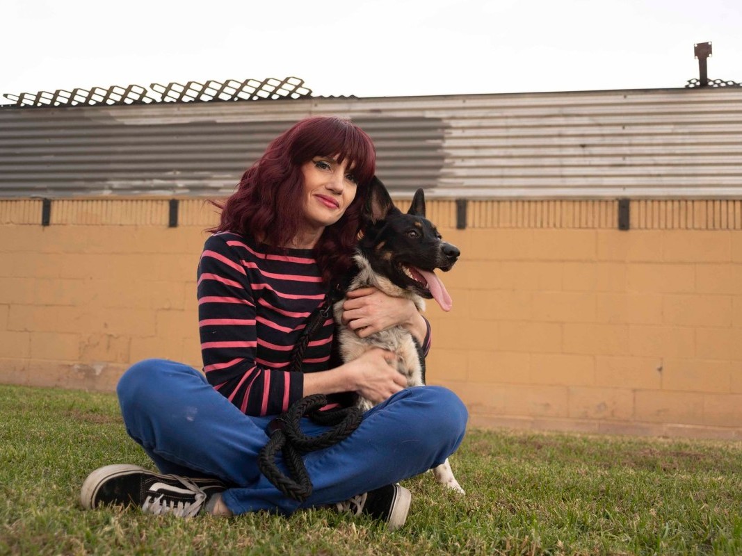 Stephanie Moore sits with her eight-month-old dog Spooky at a local park in Lawndale, CA, on Nov. 17, 2020. Money unexpectedly went missing from Moore's Bank of America-issued unemployment debit card.