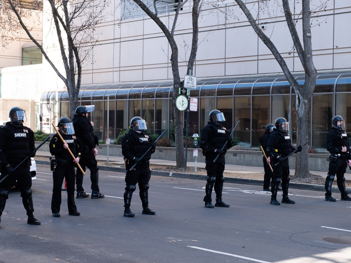 Sacramento Sheriff deputies form a line outside the County Jail during a protest on Wednesday, Jan. 20, 2021.