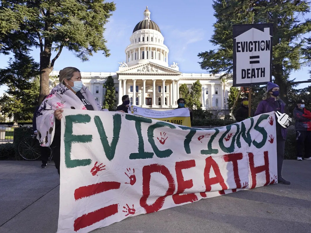 Demonstrators calling for lawmakers and Gov. Gavin Newsom to pass rent forgiveness and stronger eviction protections legislation gather in front of the Capitol in Sacramento on Jan. 25, 2021.