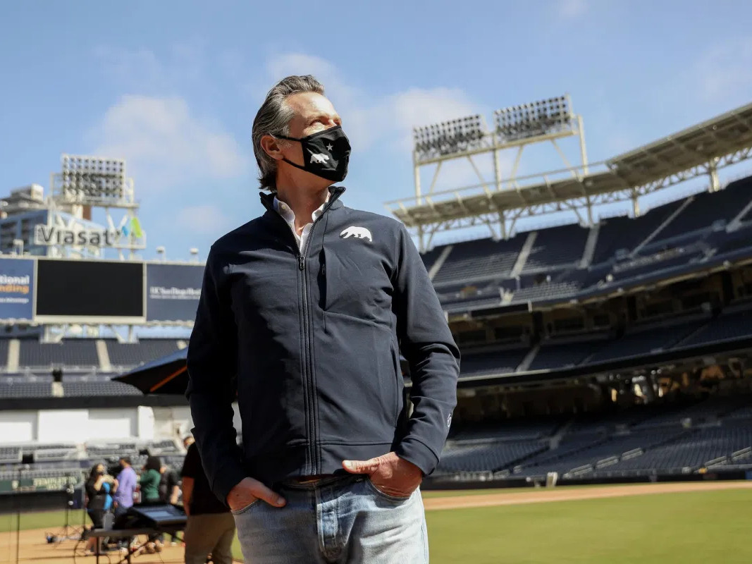 Governor Gavin Newsom stands on the field before a news conference at Petco Park on Feb. 8, 2021. Tonight, Gov. Newsom will give the State of the State address at Dodger Stadium in Los Angeles.