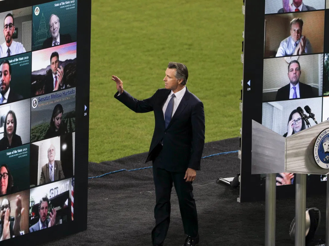 Gov. Newsom waves to virtual guests during the State of the State address at Dodger Stadium on March 9, 2021.