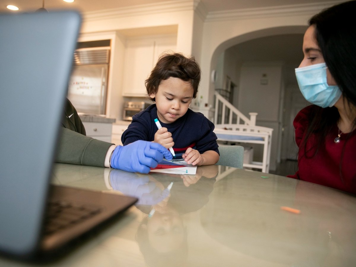 Jonathan, 4, works on an art project with help from his therapist, left, and mother, Natalia Acosta, right, during online preschool at his him in Tracy on March 3, 2021.