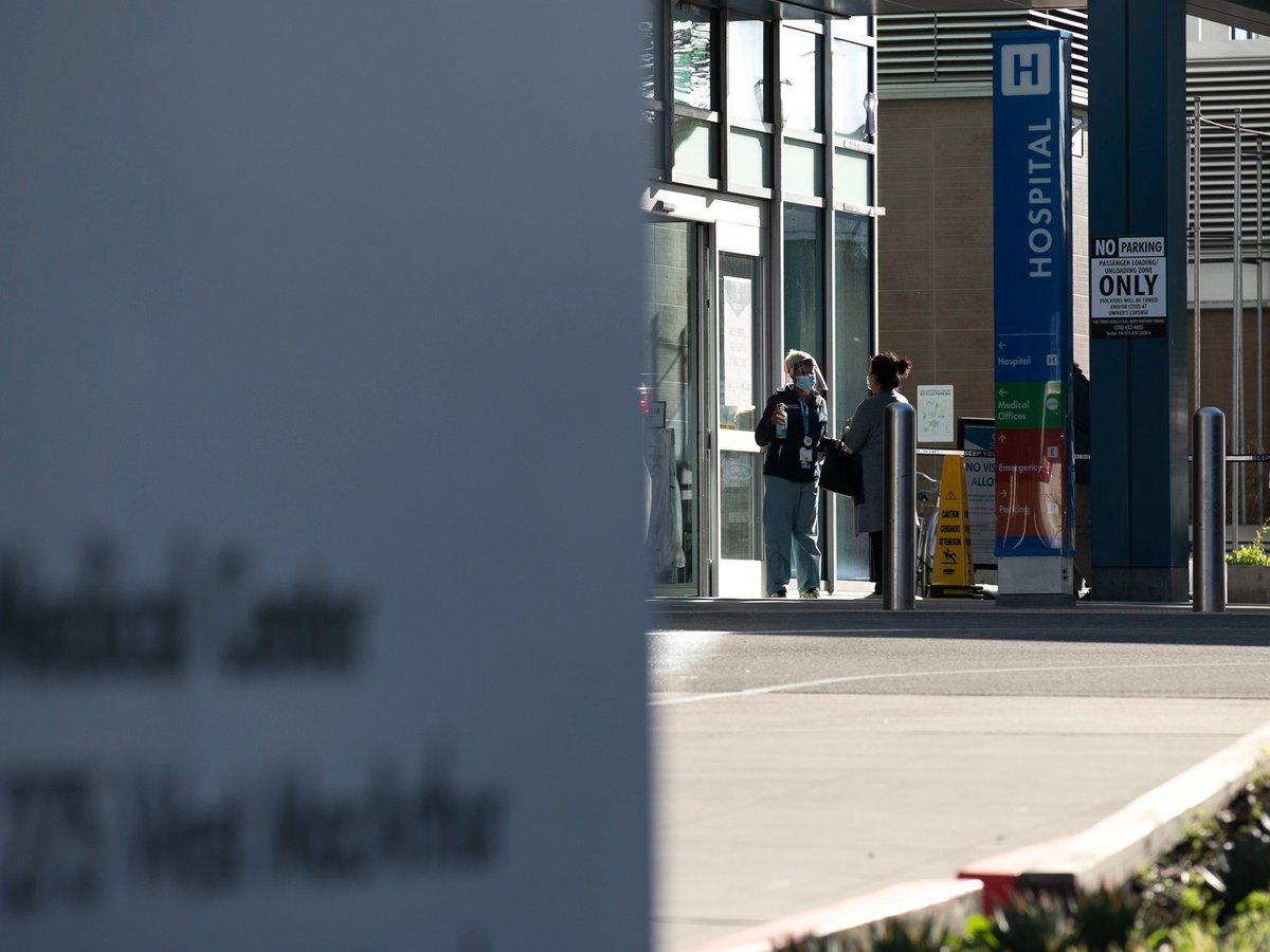 Patients and hospital staff wore masks outside of Kaiser Permanente Oakland Medical Center on Feb. 12, 2021. Many California hospitals are opening up to more visitors.