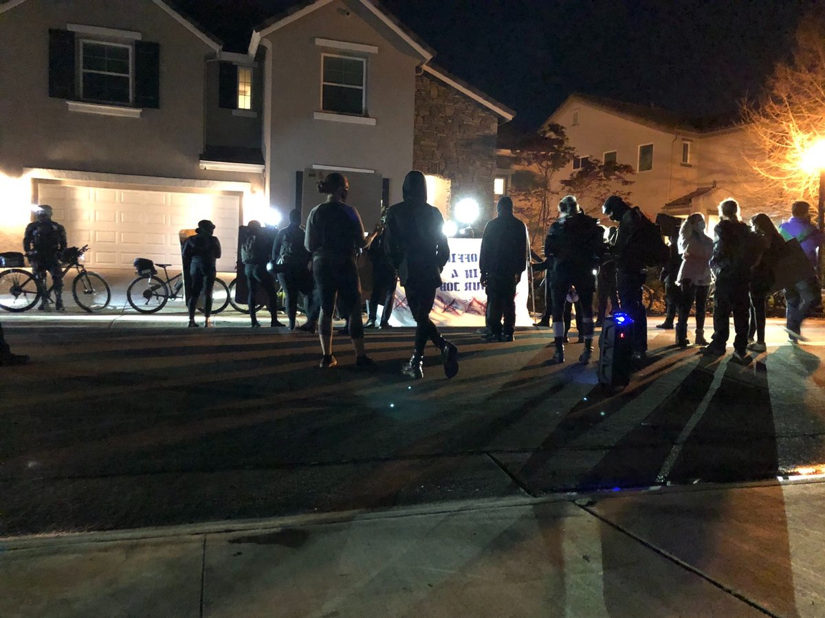 Demonstrators gather near the home of City Manager Howard Chan March 28, 2021.