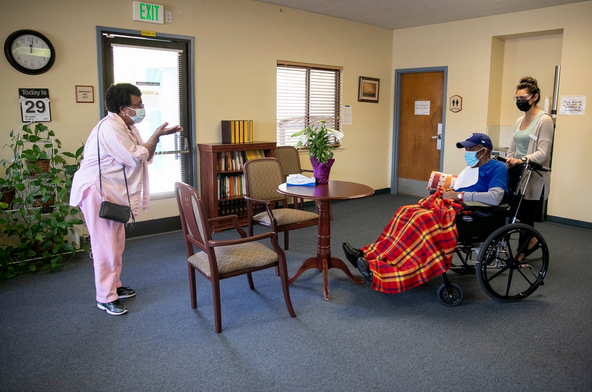 Ouida Dill, left, blows a kiss to her husband, David, at the end of their visit at Lincoln Glen Skilled Nursing Facility in San Jose. David has been a resident at Lincoln Glen for more than four years.