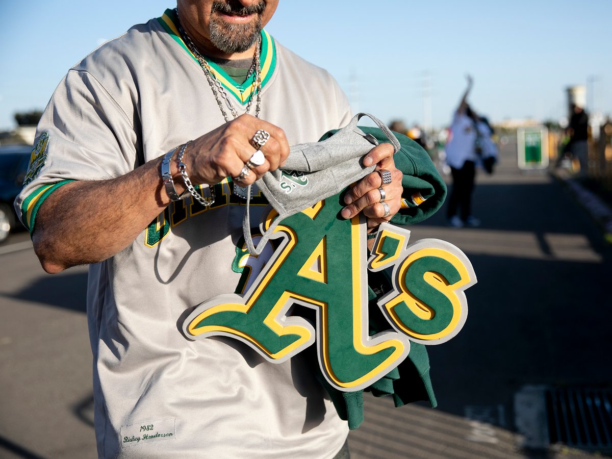 Andrew Rodriguez of Union City organizes his A’s swag as he gets in line to enter the Coliseum before the start of the Oakland Athletics season opener on April 1, 2021 in Oakland, Calif.