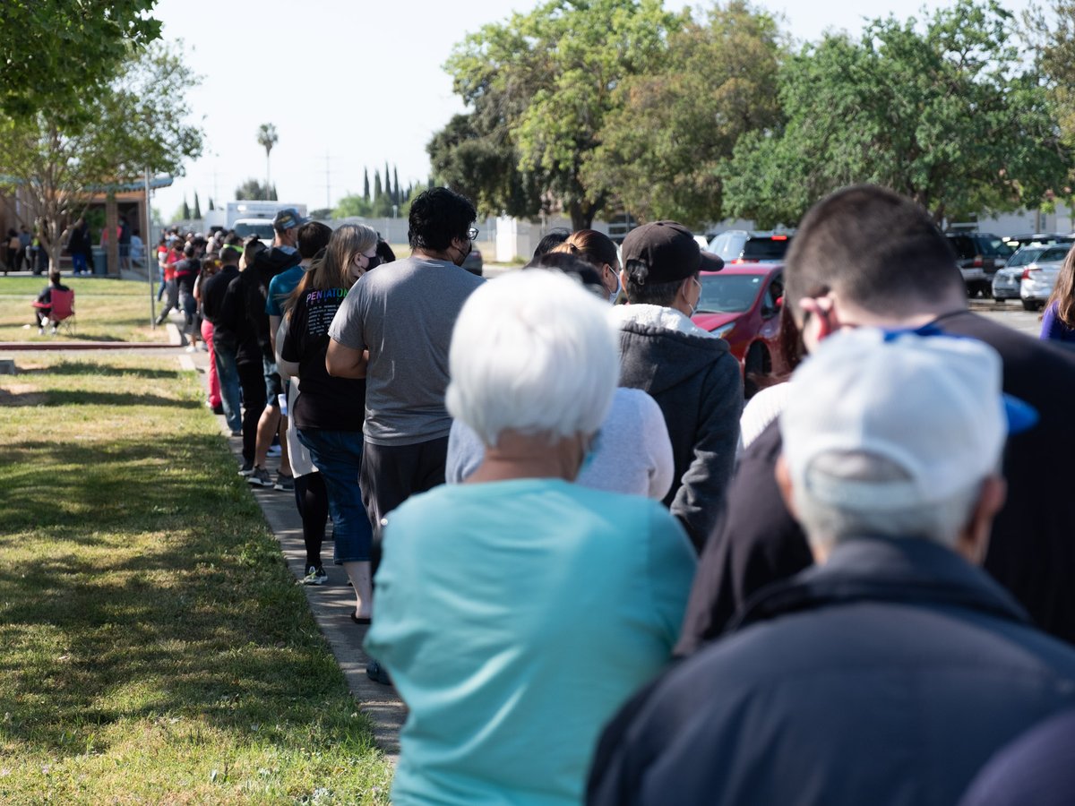 People wait in line for a COVID-19 vaccine at Luther Burbank high school Tuesday, April 13, 2021.