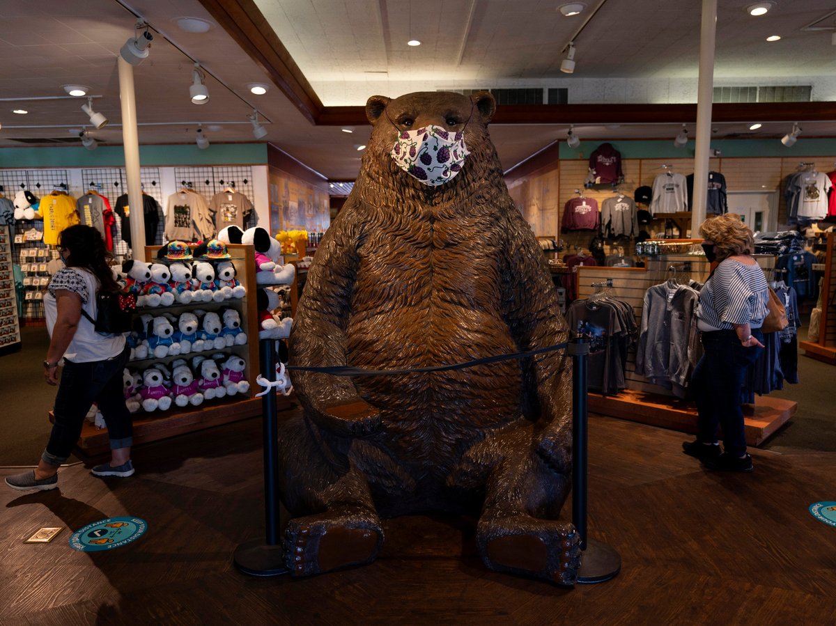 A large mask is put on a bear statue at a gift shop during the Knott's Taste of Boysenberry Festival at Knott's Berry Farm in Buena Park, Calif., Tuesday, March 30, 2021.