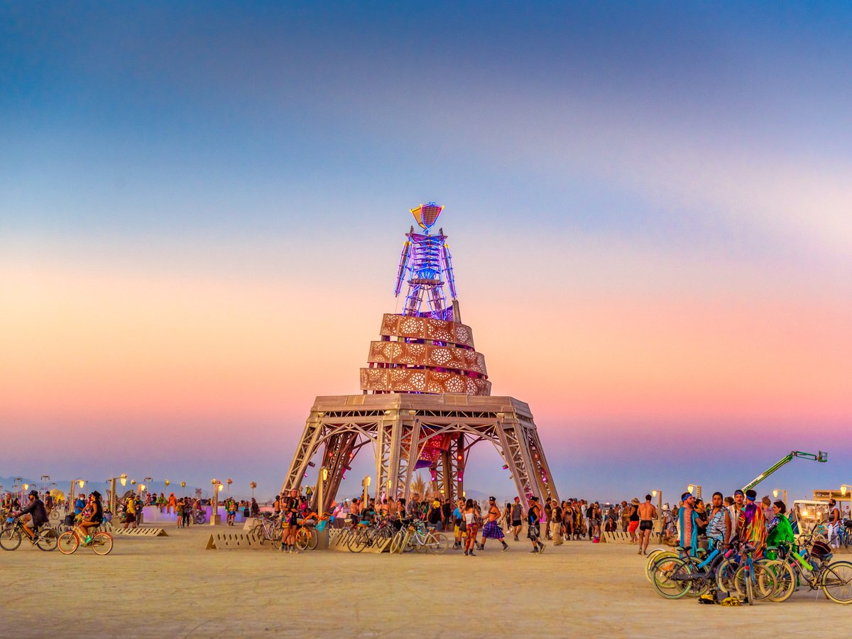 People gather around "the Man" sculpture at Buring Man 2019.