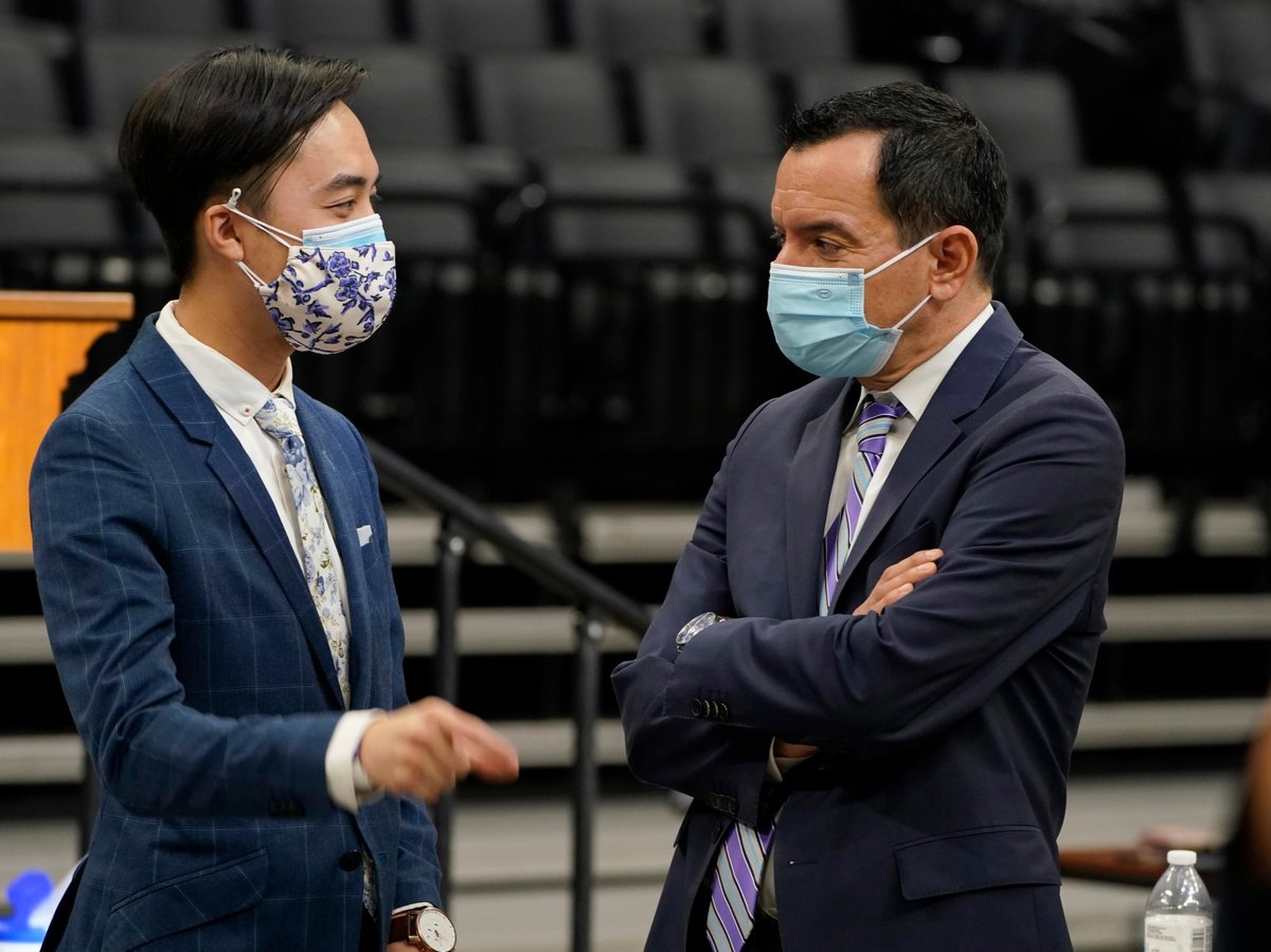 Democratic freshman Assemblyman Alex Lee, left, talks with Assembly Speaker Anthony Rendon, D-Lakwood, after swearing-in ceremonies in Sacramento, Calif., Monday, Dec. 7, 2020.