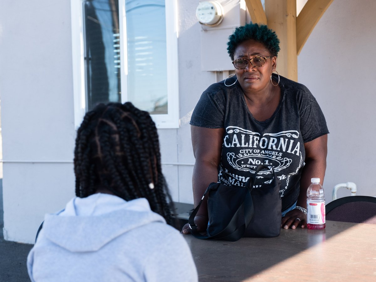 Sherri Kirk, program manager, talks to a youth about a dispute they had with another program attendee at Neighborhood Wellness Foundation in Sacramento Monday, May 10, 2021.
