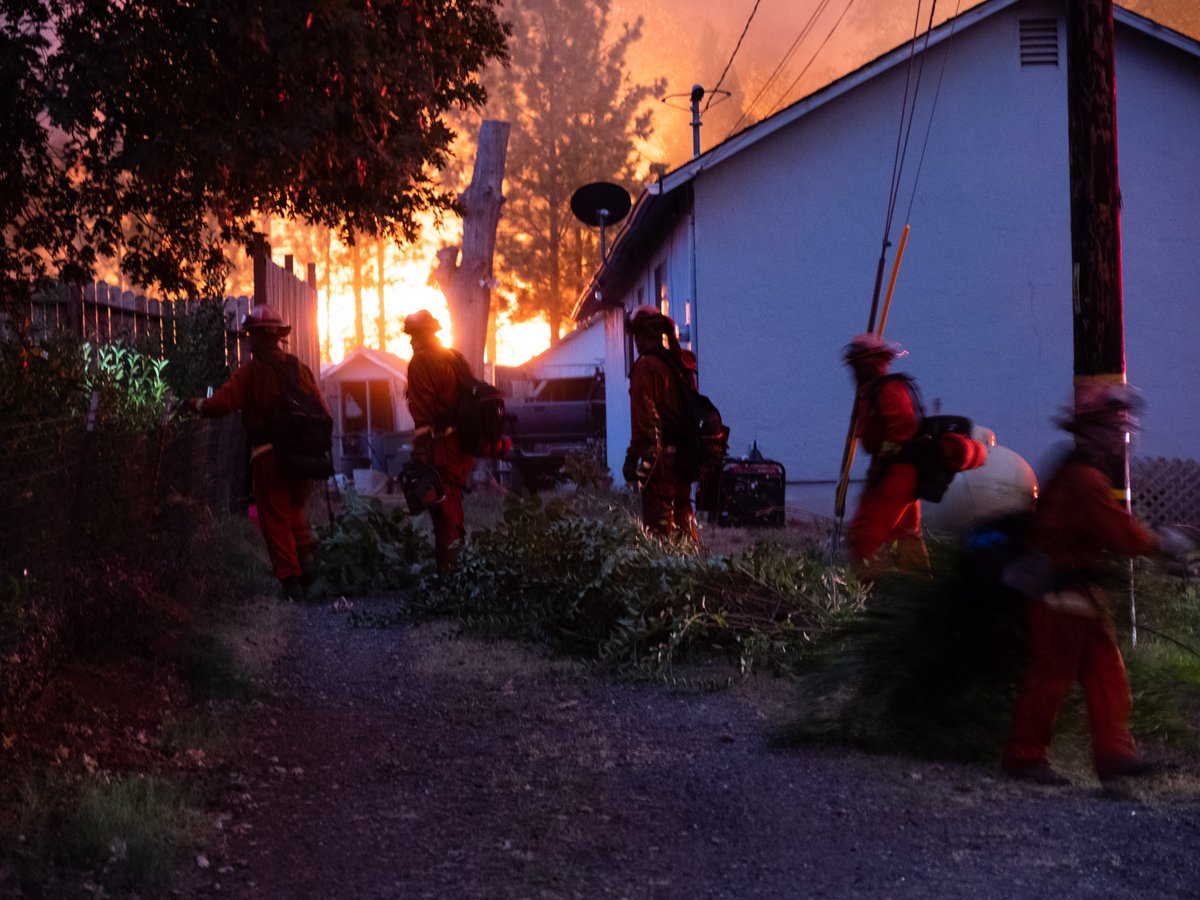 An inmate fire crew defends homes from the River Fire Wednesday, Aug. 4, 2021.