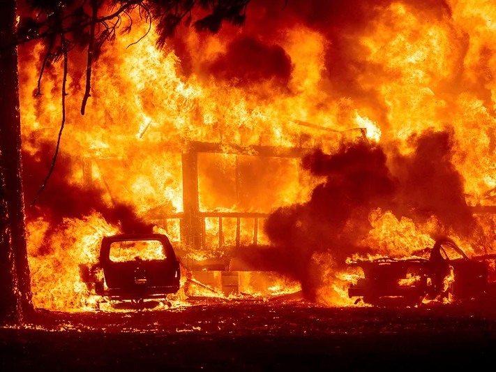 Flames consume a home on Highway 89 as the Dixie Fire tears through the Greenville community of Plumas County, Calif., on Wednesday, Aug. 4, 2021.