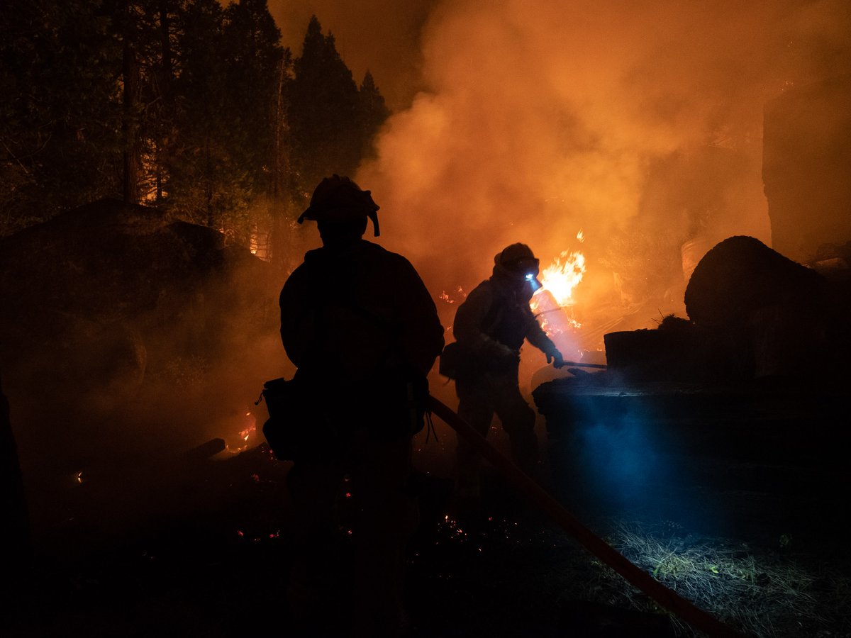Firefighters protect homes in Christmas Valley from the Caldor Fire Monday, Aug. 30, 2021.