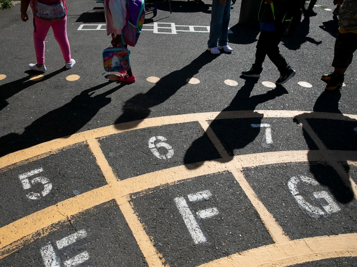 Rising first graders walk to their classroom at the start of the day during summer session at Laurel Elementary in Oakland on June 11, 2021.