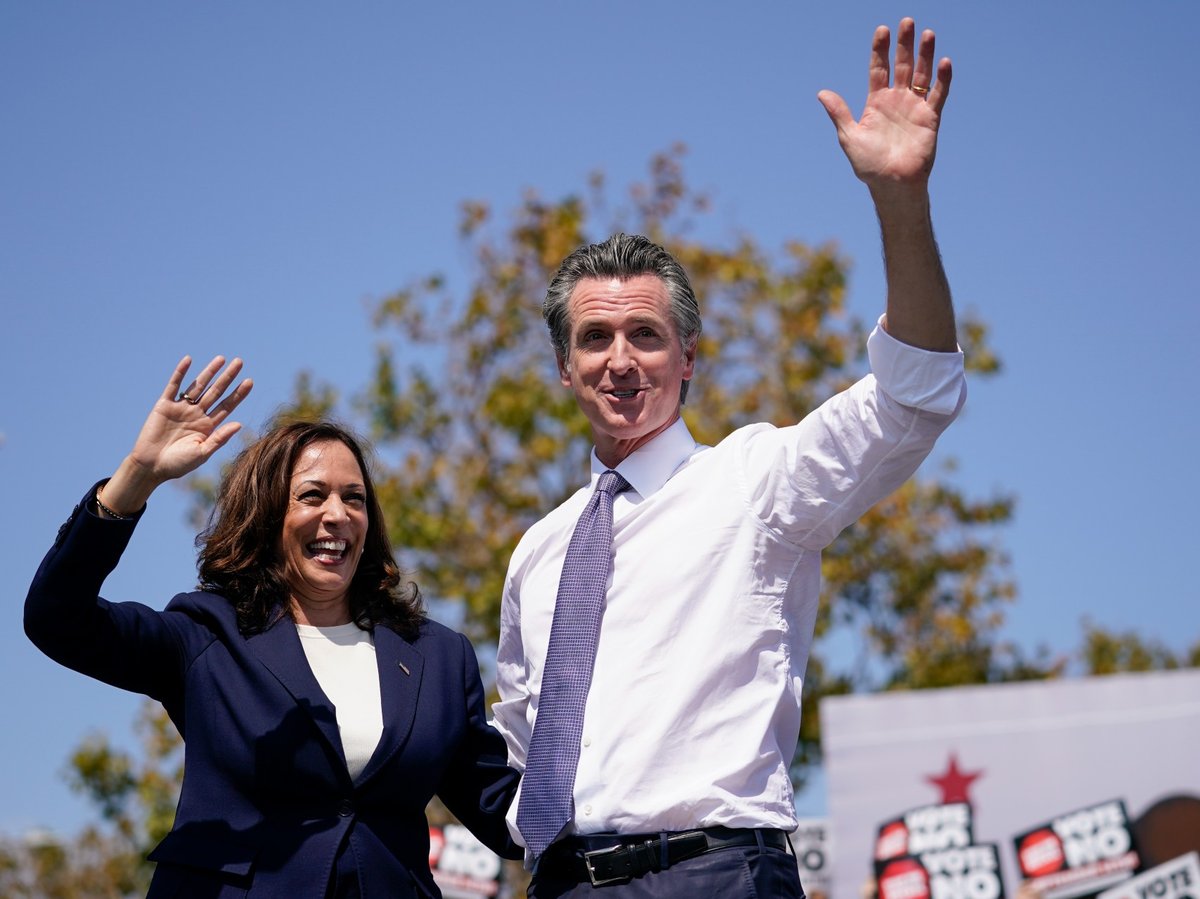 Vice President Kamala Harris waves with California Gov. Gavin Newsom during a campaign event at the IBEW-NECA Joint Apprenticeship Training Center in San Leandro, Calif., Wednesday, Sept. 8, 2021.