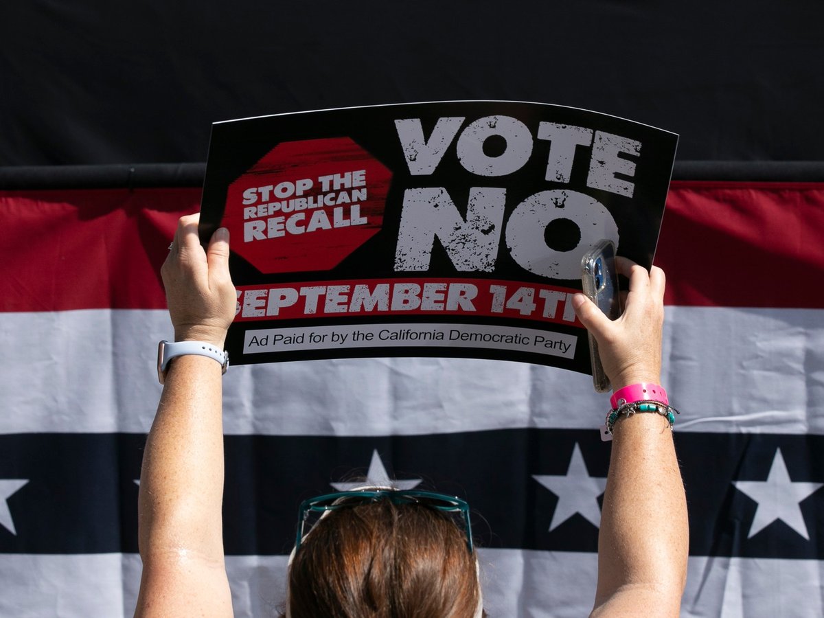 A Gavin Newsom supporter holds up a sign against the recall at a campaign event at the IBEW-NECA training center in San Leandro on Sept. 8, 2021.