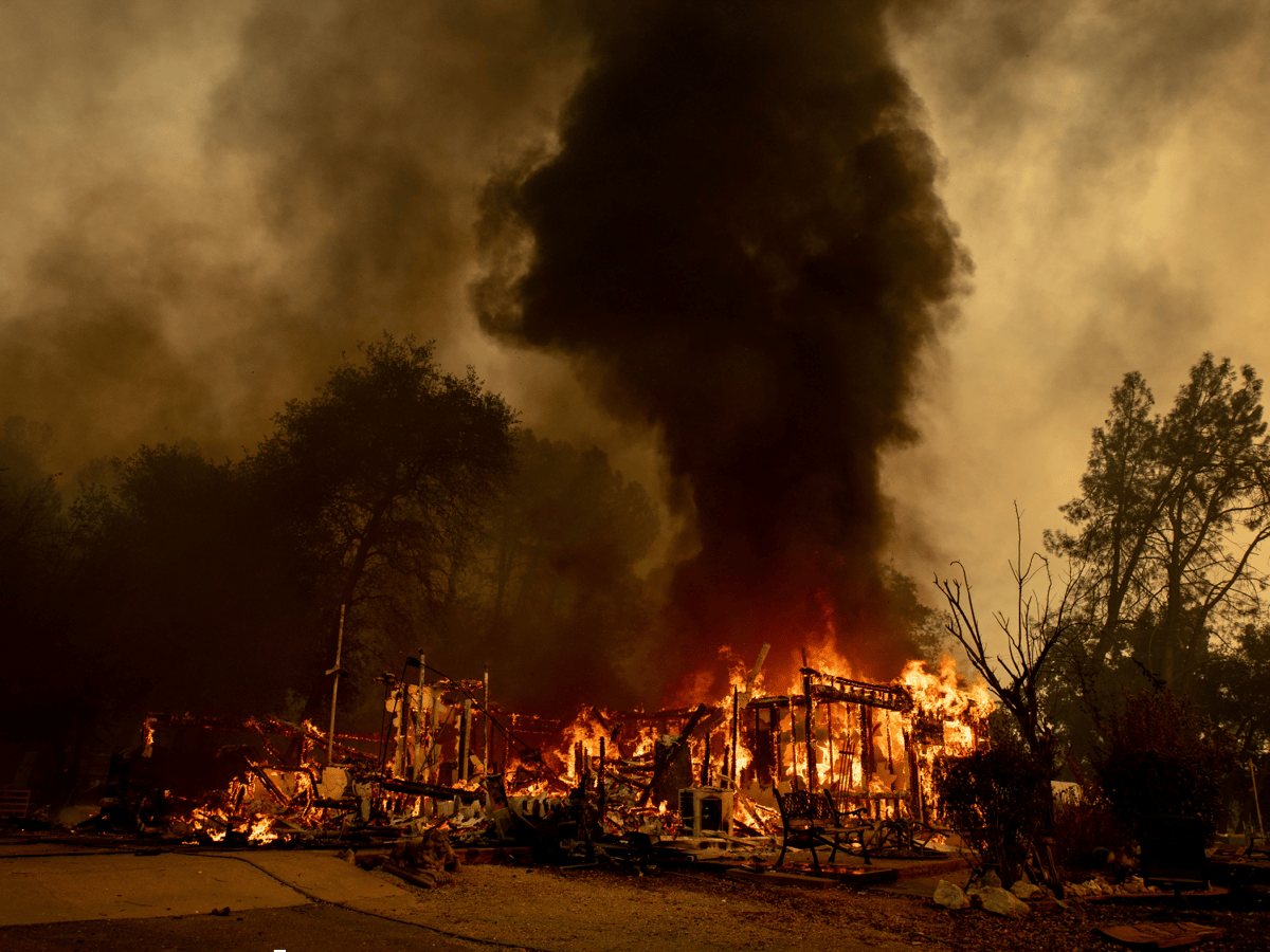 Flames consume a house near Old Oregon Trail as the Fawn Fire burns north of Redding in Shasta County, Calif., on Thursday, Sept. 23, 2021.