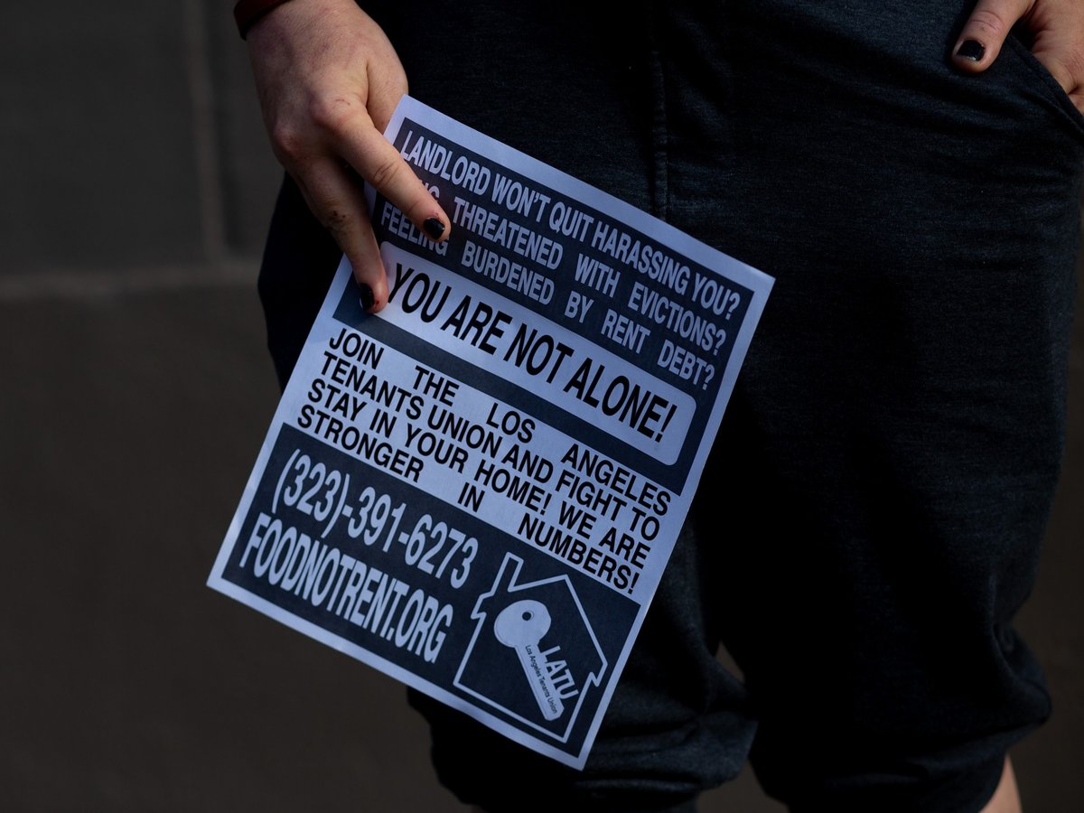 Jordan Lyric holds a rent strike poster in Los Angeles on May 6, 2021.