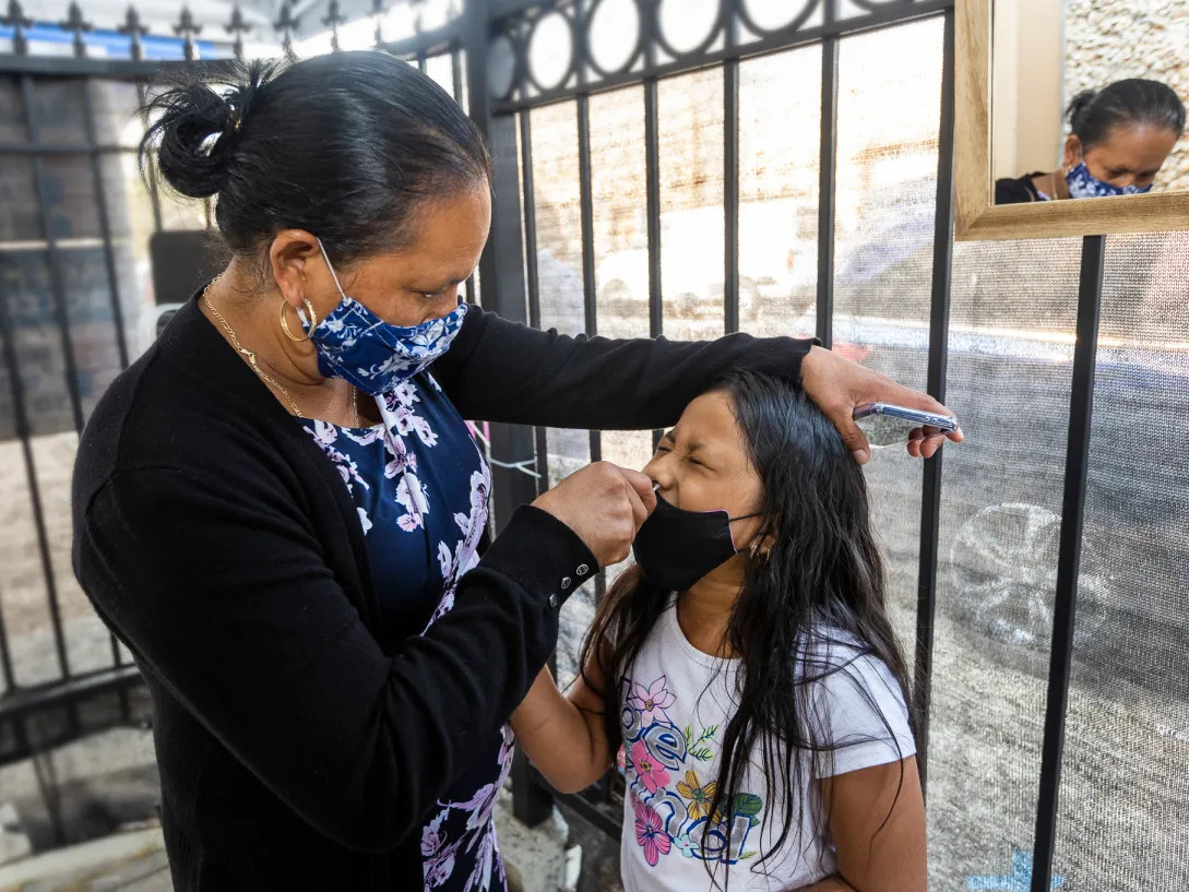 Maria Jimenez swabs her 7 year old daughter, Glendy Perez, for a COVID-19 test at Canal Alliance in San Rafael on Sept. 25, 2021.