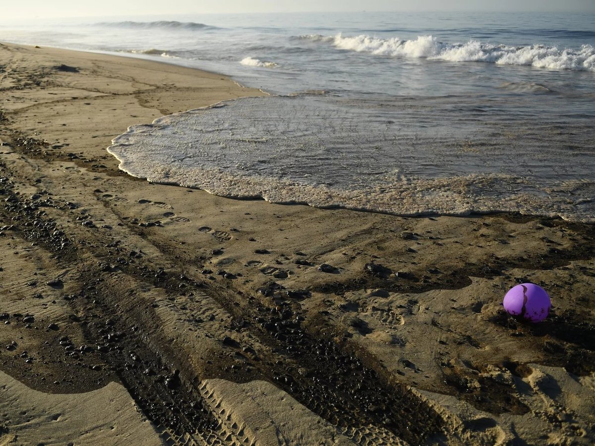 Oil is seen on the beach in Huntington Beach, California on October 3, 2021, after a pipeline breach connected to an oil rig off shore started leaking oil, according to an Orange County Supervisor.