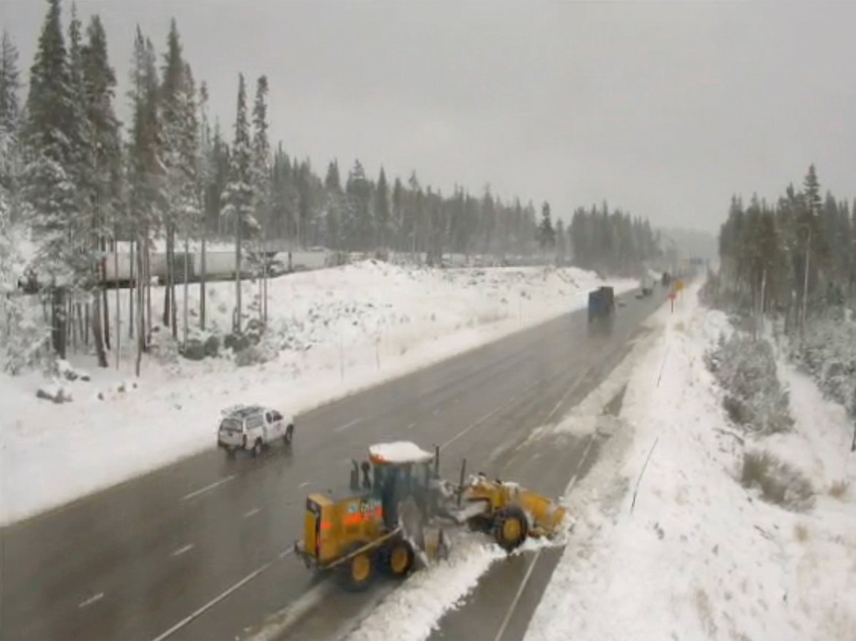 In this image from a Caltrans remote traffic video camera, snow is cleared from a shoulder lane along Interstate 80 at Donner Summit, Calif., Monday, Oct. 18, 2021.