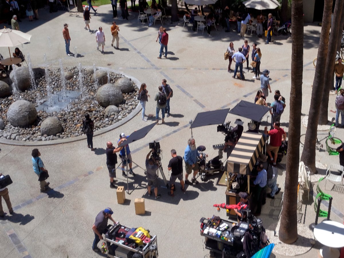 In this May 1, 2017 file photo production crew, extras, and camera operators get ready to film an episode of NCIS:Los Angeles on location in Los Angeles.