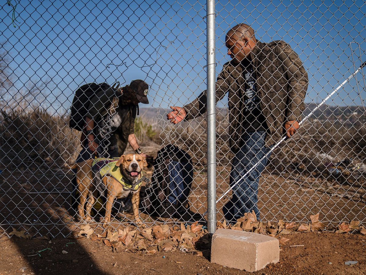 William Brown, right, and Josh Lowe with his dog near the encampment where they both were staying before it was cleared by Caltrans in San Clemente.