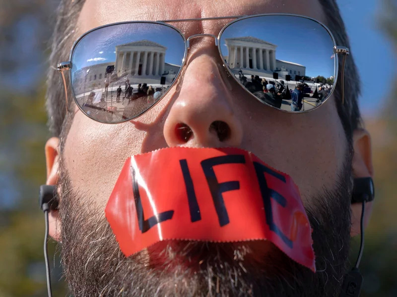 An anti-abortion activist rallies outside the Supreme Court on Nov. 1, as arguments about Texas' abortion law begin. The court has allowed the law to remain in place for now.