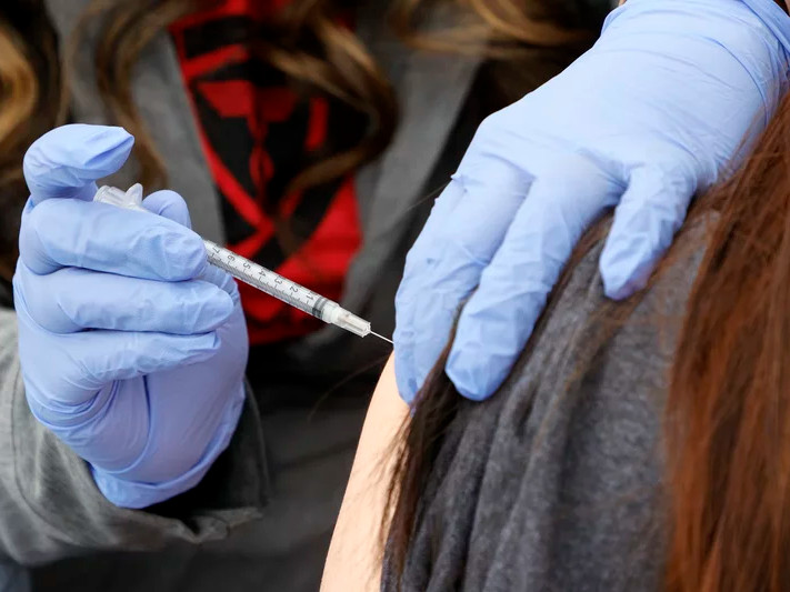 A woman receives a booster shot at a pop-up vaccination clinic in Las Vegas on Dec. 21.