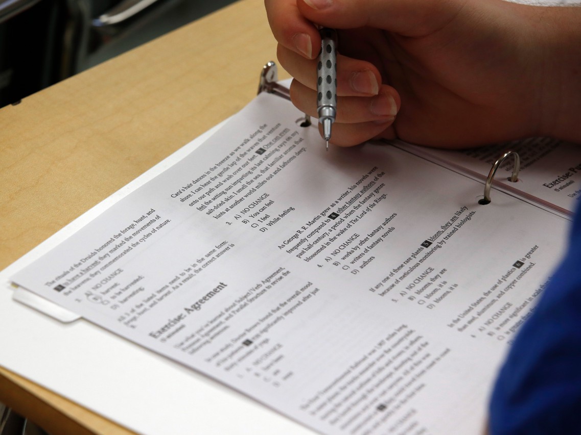In this photo taken Jan. 17, 2016, a student looks at questions during a college test preparation class at Holton Arms School in Bethesda, Md.