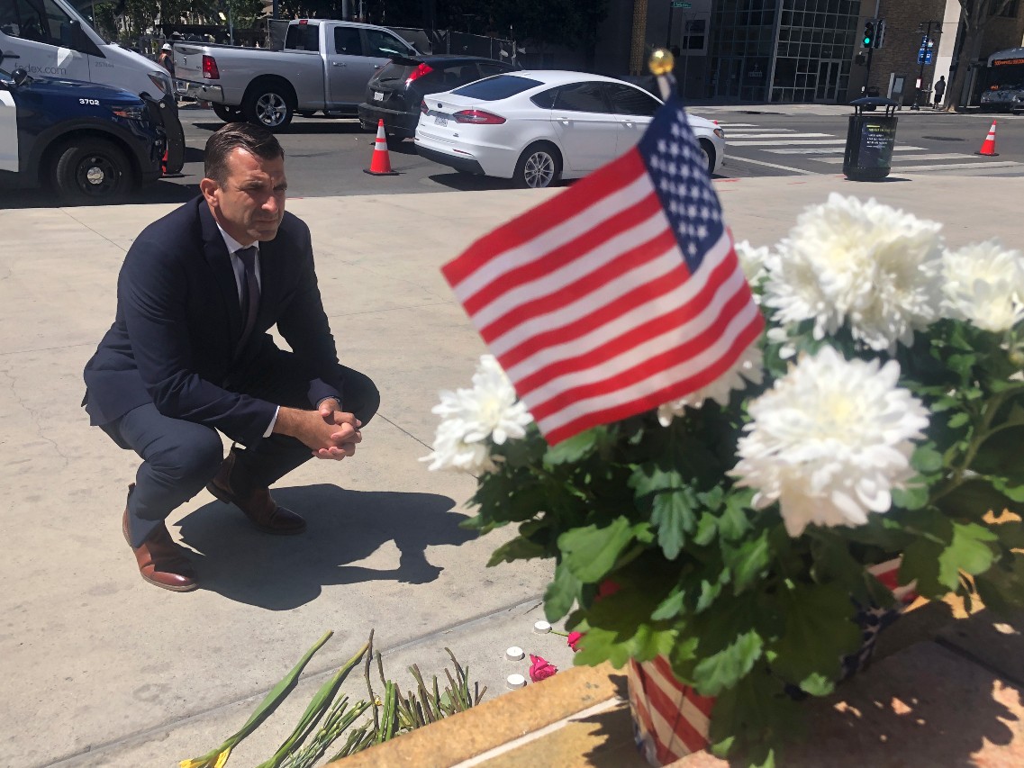 San Jose Mayor Sam Liccardo stops to view a makeshift memorial for the rail yard shooting victims in front of City Hall in San Jose, Calif., on Thursday, May 27, 2021.
