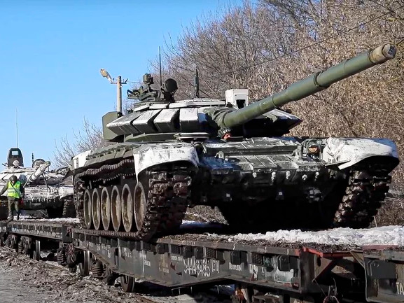 In this photo taken from video provided by the Russian Defense Ministry Press Service on Wednesday, Russian army tanks are loaded onto railway platforms to move back to their permanent base after drills in Russia.