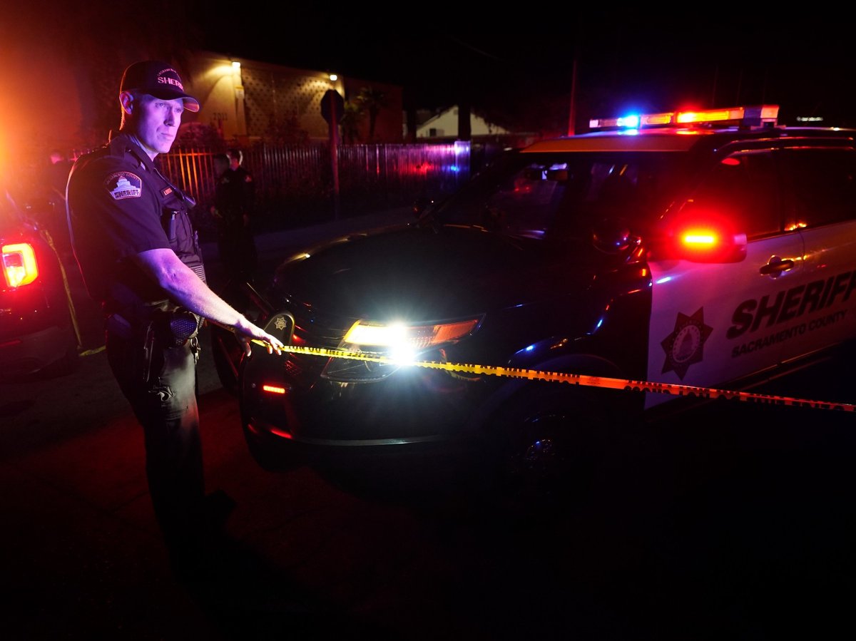 Sacramento County Sheriff's deputies stand by police tape that blocks the street leading to a church where a shooting occurred with multiple victims, in Sacramento, Calif., Monday, Feb. 28, 2022.
