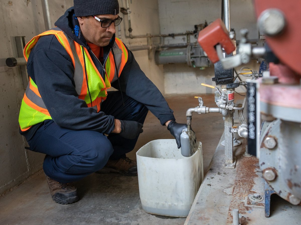 Patrick Green, a utilities plant operator in Modesto, California, siphons wastewater sludge to be analyzed for evidence of SARS-CoV-2, the virus that causes covid.