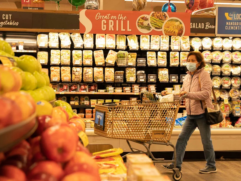 A woman shops for fruits at a supermarket on March 10, 2022 in San Mateo County, California.