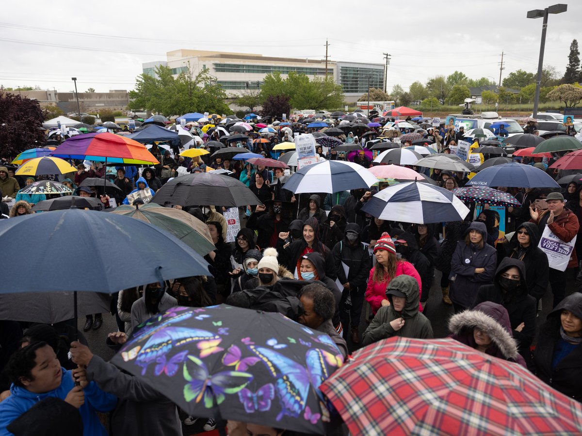 Sacramento City Unified School District staff and supporters listen to Dolores Huerta give a speech in the rain at Rosemont High School, on Monday, March 28, 2022.