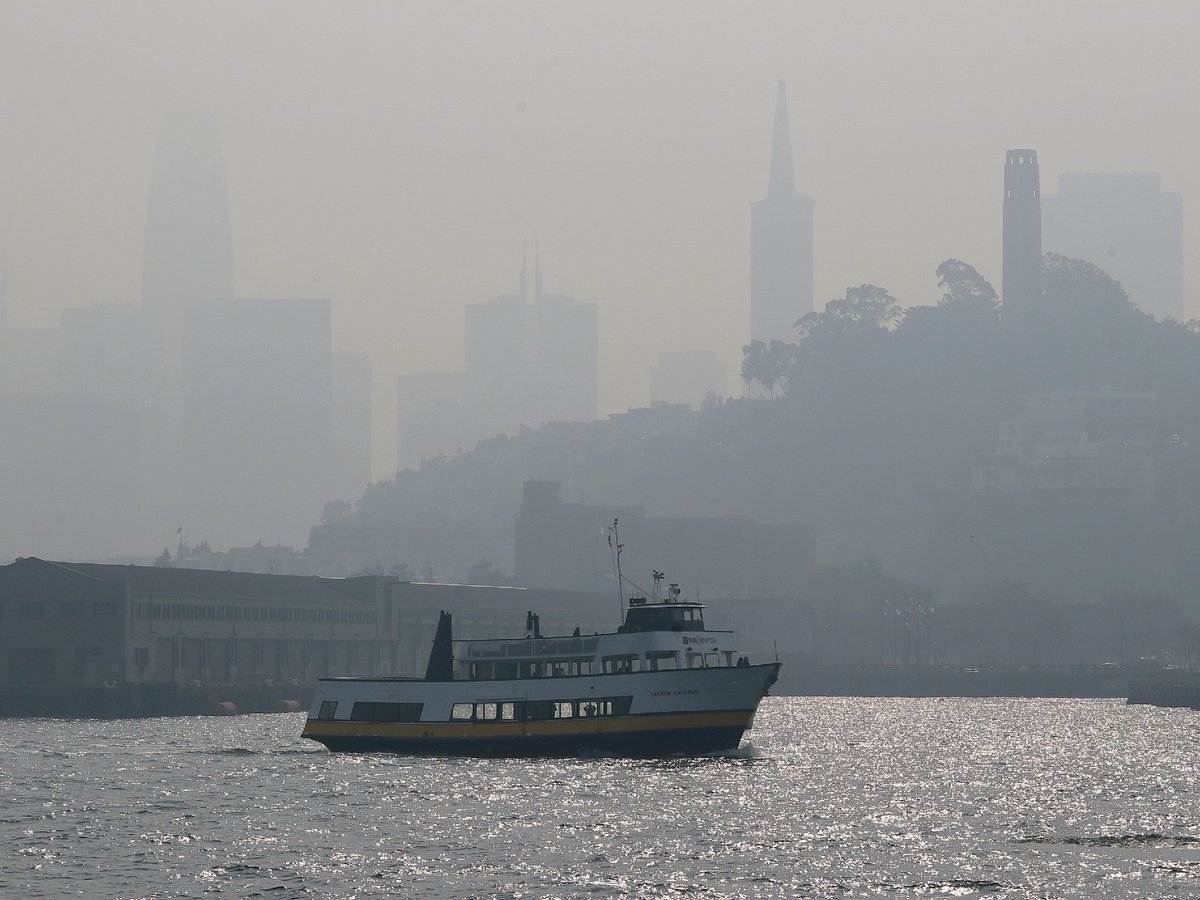 The skyline is obscured by smoke and haze from wildfires as a tour boat makes its way along the waterfront Thursday, Nov. 15, 2018, in San Francisco.