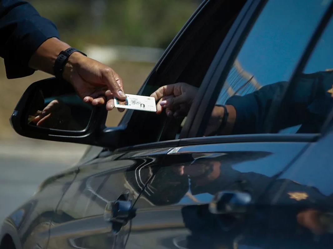 A California Highway Patrol officer stops a motorist who was suspected of speeding along Interstate 405 freeway in Westminster on April 23, 2020.