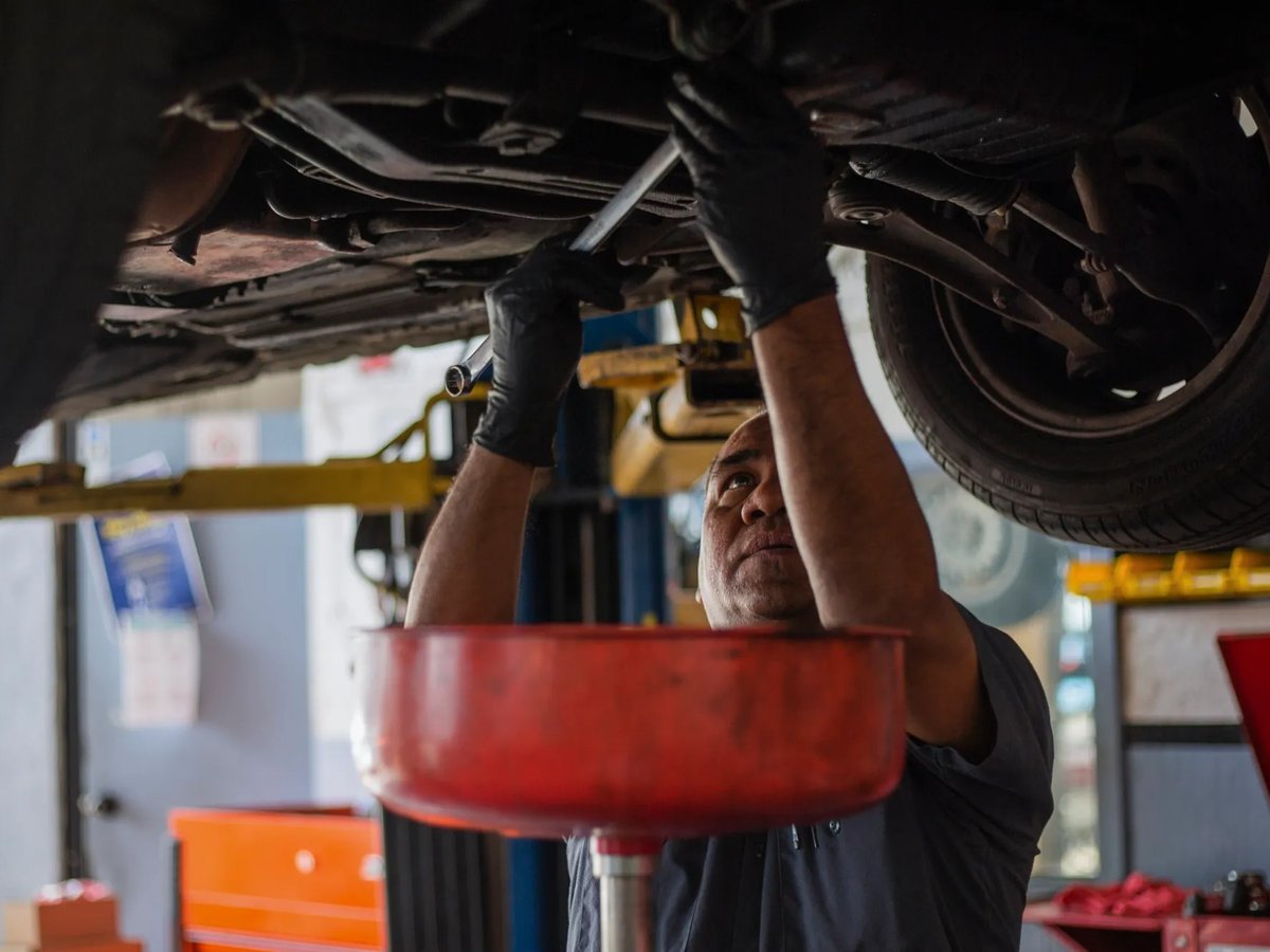 Walter Preza works on a car at J & R Auto Repair shop mechanic in San Francisco.