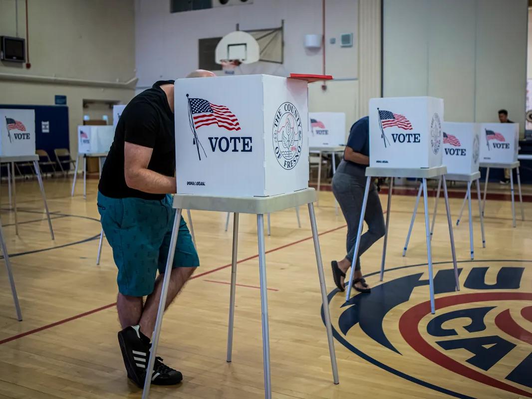 Voters fill out their ballots at a voting site at the Hamilton School gymnasium in central Fresno on June 7, 2022.
