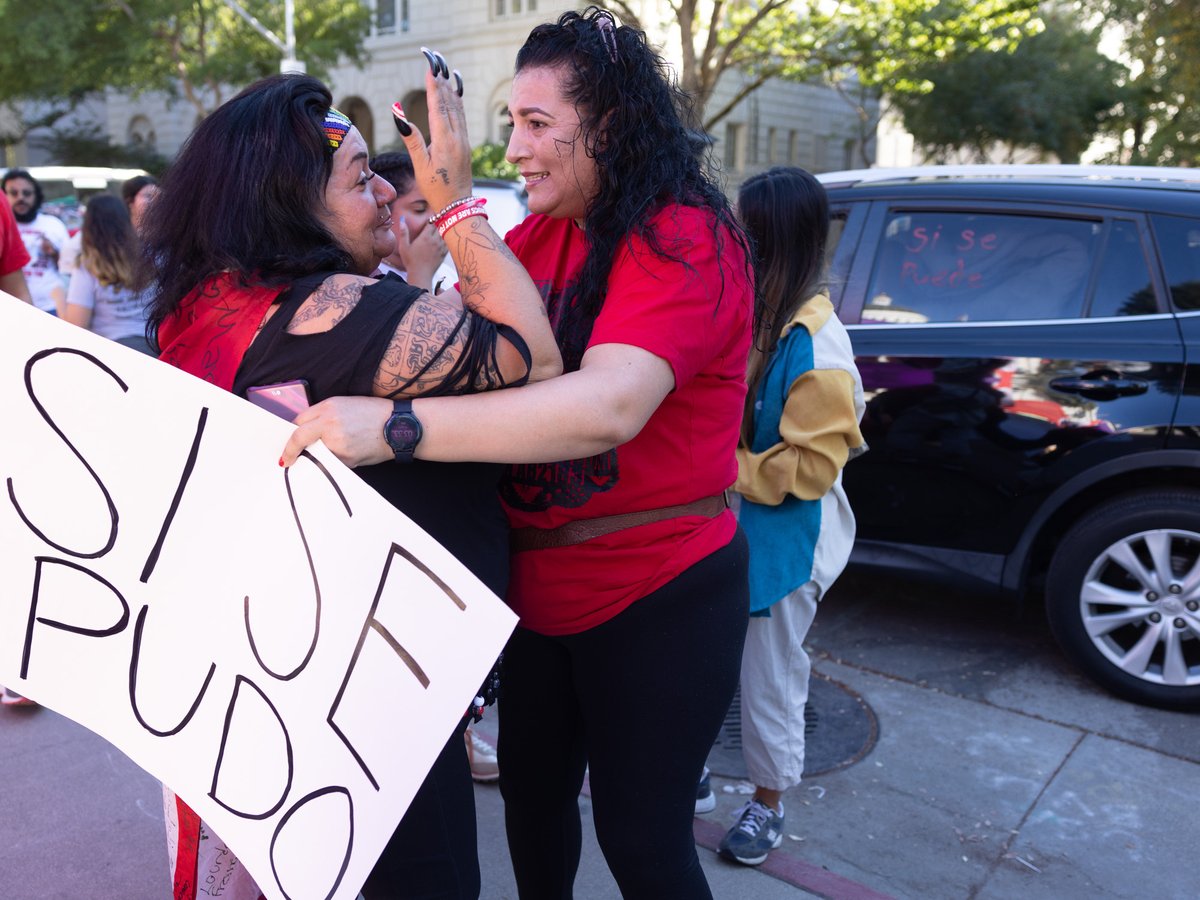Cynthia Burgos, who marched from Delano, Calif. and held vigil for weeks in front of the State Capitol celebrates with Mary Guzman, a supporter from Elk Grove on Wednesday, Sept. 28, 2022.