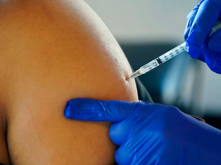 A Jackson, Miss., resident receives a Pfizer booster shot from a nurse at a vaccination site Feb. 8.