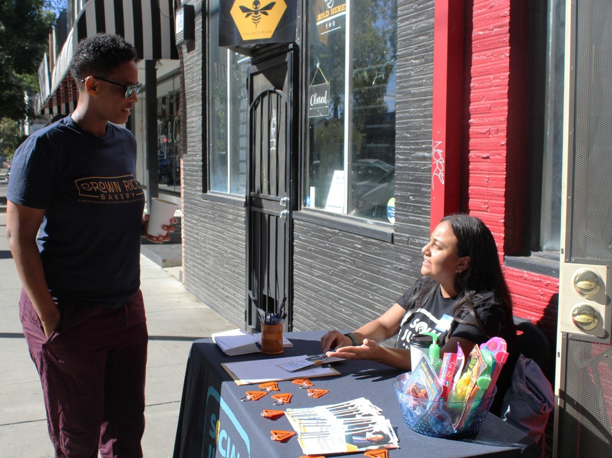 Social Justice PolitiCorps Community Organizer Sarah Rabanales talks with J Jordan about local politics outside of DRIP Espresso in Sacramento, Calif. on Sept. 28, 2022.